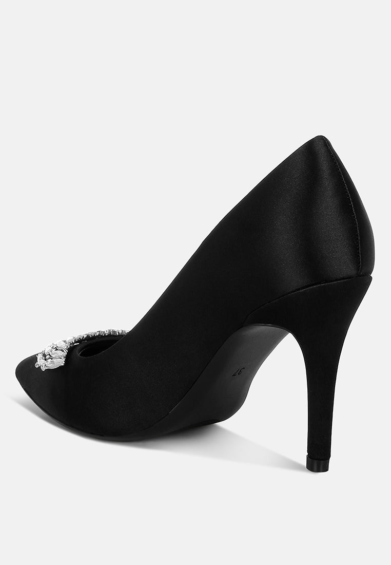 Black Diamante Brooch Detail Satin Pumps by London Rag – satin pointed-toe pumps with a diamante brooch detail, stiletto heel, and cushioned insole, angled view