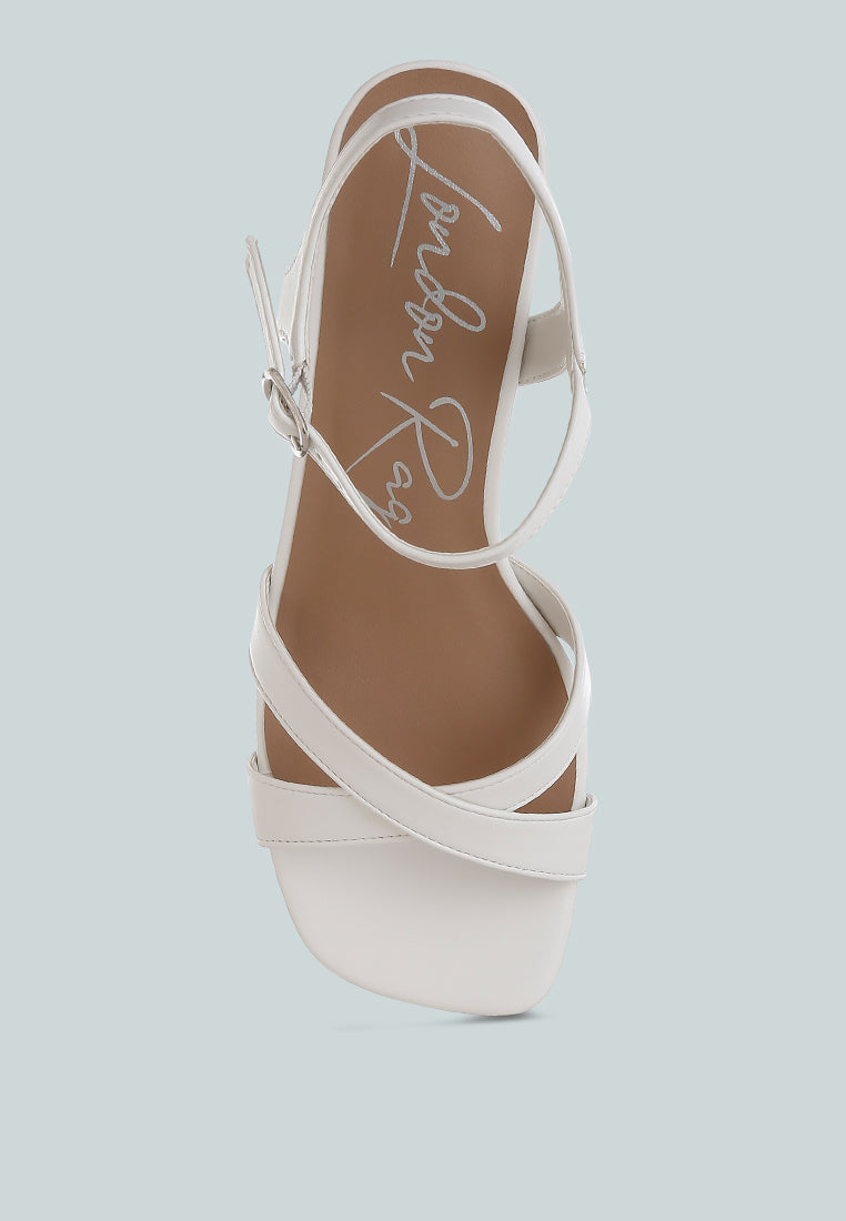 White Square Toe Block Heel Sandals by London Rag – square-toe block heel sandals in faux leather with an ankle strap and cushioned insole, sole and heel view